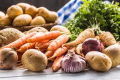Assortment of fresh vegetables on wooden table. Carrot parsnip garlic celery onion and kohlrabi royalty free stock image Assortment of fresh vegetables on wooden table. Carrot parsnip garlic celery onion and kohlrabi royalty free stock image