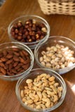 Assortment of mixed nuts and wicker basket on wood table background stock photography Assortment of mixed nuts and wicker basket on wood table background stock photography
