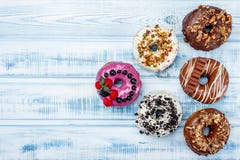 Assortment of triangle-shaped donuts on old wood background. Space for text. Top view stock photo Assortment of triangle-shaped donuts on old wood background. Space for text. Top view stock photo