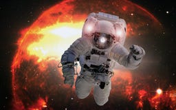 Astronaut in outer space on the orange giant star background. Elements of this image furnished by NASA stock image Astronaut in outer space on the orange giant star background. Elements of this image furnished by NASA stock image