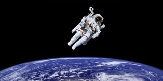 Astronaut in outer space over the planet earth