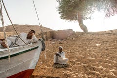 Aswan Egypt 21.05.18 Local people waiting for customers during Sunset Sand dunes Coastline Nile river stock photography Aswan Egypt 21.05.18 Local people waiting for customers during Sunset Sand dunes Coastline Nile river stock photography