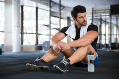 Athlet sitting on the floor in gym stock image Athlet sitting on the floor in gym stock image