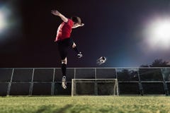 Athlete kicking soccer ball towards goal stock photos Athlete kicking soccer ball towards goal stock photos