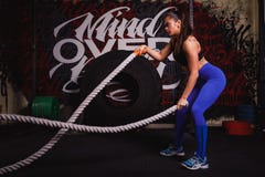 Athletic woman doing some crossfit exercises with a heavy rope royalty free stock photos Athletic woman doing some crossfit exercises with a heavy rope royalty free stock photos