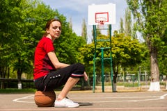 Athletic Woman Sitting On Basketball On Court Royalty Free Stock Photos Athletic Woman Sitting On Basketball On Court Royalty Free Stock Photos
