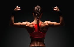 Athletic Young Woman Showing Muscles Of The Back Royalty Free Stock Photo