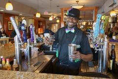 ATLANTA, GEORGIA, USA - MARCH 19, 2019: A friendly bartender is mixing a cocktail. royalty free stock photos ATLANTA, GEORGIA, USA - MARCH 19, 2019: A friendly bartender is mixing a cocktail. royalty free stock photos