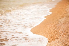 Atmospheric, melancholic mood, blurred background. View of shell beach and sea foaming waves. For design mockup. royalty free stock images Atmospheric, melancholic mood, blurred background. View of shell beach and sea foaming waves. For design mockup. royalty free stock images