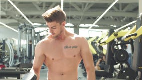 Atrakcyjny sportowiec opracowywa z dumbbells w gym zdjęcie wideo Atrakcyjny sportowiec opracowywa z dumbbells w gym zdjęcie wideo