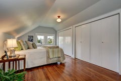Attic bedroom interior with vaulted ceiling and hardwood floor. royalty free stock photography Attic bedroom interior with vaulted ceiling and hardwood floor. royalty free stock photography
