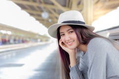 Attractive beautiful woman is waiting train for traveling around the city. stock photo Attractive beautiful woman is waiting train for traveling around the city. stock photo