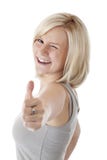 Attractive blonde woman holds thumb up and winks Stock Image Attractive blonde woman holds thumb up and winks Stock Image