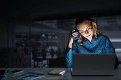 Attractive Blonde Working On Laptop In Dark Office. Mixed Media Stock Photography Attractive Blonde Working On Laptop In Dark Office. Mixed Media Stock Photography