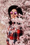 Attractive brunette girl near a almond tree with many flowers stock images Attractive brunette girl near a almond tree with many flowers stock images