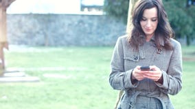 Attractive Businesswoman outdoor with mobile phone and coffee stock video footage Attractive Businesswoman outdoor with mobile phone and coffee stock video footage