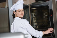 attractive chef standing near oven royalty free stock photos attractive chef standing near oven royalty free stock photos