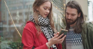 Young beautiful couple share memories and pictures on social media with online mobile app. stock video footage Young beautiful couple share memories and pictures on social media with online mobile app. stock video footage