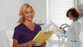 Attractive female doctor examining papers at the hospital stock images Attractive female doctor examining papers at the hospital stock images