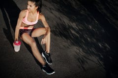 Attractive Fitness Young Woman Rest After Exercises Oudoor. Sporty Woman Holding Protein Shake After Tranning. Stock Photo