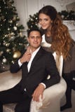 Attractive girl hugging handsome man on armchair. Romantic coupl royalty free stock image Attractive girl hugging handsome man on armchair. Romantic coupl royalty free stock image