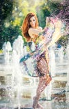 Attractive Girl In Multicolored Short Dress Playing With Water In A Summer Hottest Day. Girl With Wet Dress Enjoying Fountains Stock Photos Attractive Girl In Multicolored Short Dress Playing With Water In A Summer Hottest Day. Girl With Wet Dress Enjoying Fountains Stock Photos