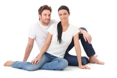 Attractive loving couple sitting on floor smiling stock images Attractive loving couple sitting on floor smiling stock images