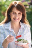 Attractive Middle Aged Woman Eating Healthy Salad In Garden Royalty Free Stock Photos Attractive Middle Aged Woman Eating Healthy Salad In Garden Royalty Free Stock Photos