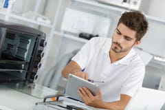Attractive repairman concentrated at work Stock Photo Attractive repairman concentrated at work Stock Photo