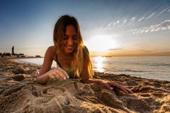 https://thumbs.dreamstime.com/t/attractive-sexy-woman-bikini-laying-sand-lonely-beach-sunrise-sunset-76856082.jpg