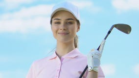 Attractive woman in golfer uniform and with club posing to camera, luxury hobby stock video Attractive woman in golfer uniform and with club posing to camera, luxury hobby stock video