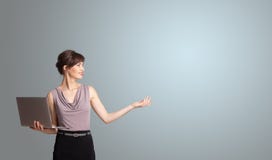 Attractive woman holding a laptop with copy space royalty free stock photography Attractive woman holding a laptop with copy space royalty free stock photography