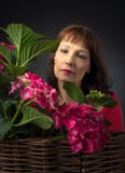 Attractive woman near a bush coral hydrangeas stock photo Attractive woman near a bush coral hydrangeas stock photo