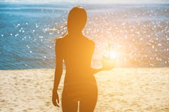 Attractive, young girl holding a coconut to drink while relaxing at a resort near the ocean. royalty free stock images Attractive, young girl holding a coconut to drink while relaxing at a resort near the ocean. royalty free stock images