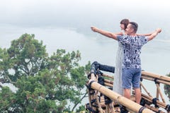 Attractive Young Loving Romantic Couple On The Tropical Fog Landscape Of Bali Island, Indonesia. Stock Photos Attractive Young Loving Romantic Couple On The Tropical Fog Landscape Of Bali Island, Indonesia. Stock Photos