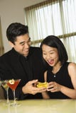 Attractive Young Man Giving Gift to Woman stock image Attractive Young Man Giving Gift to Woman stock image