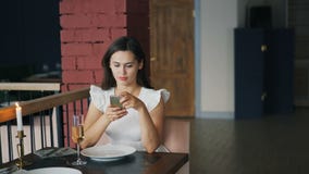 https://thumbs.dreamstime.com/t/attractive-young-woman-beautiful-dress-waiting-her-boyfriend-restaurant-sitting-table-alone-using-smartphone-141039004.jpg