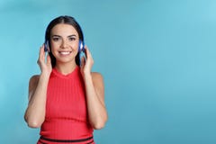 Attractive young woman enjoying music in headphones on color background stock photo Attractive young woman enjoying music in headphones on color background stock photo