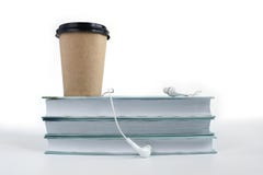 Audio book concept. Headphones, cup of coffee and stack of books on white background. Copy space for your text royalty free stock photo Audio book concept. Headphones, cup of coffee and stack of books on white background. Copy space for your text royalty free stock photo