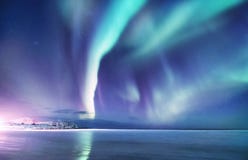 Aurora Borealis On The Lofoten Islands, Norway. Night Sky With Polar Lights. Night Winter Landscape With Aurora And Reflection On Stock Photography Aurora Borealis On The Lofoten Islands, Norway. Night Sky With Polar Lights. Night Winter Landscape With Aurora And Reflection On Stock Photography