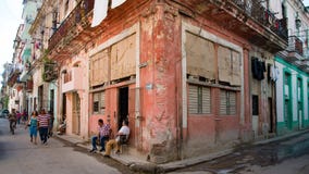The authentic side of Cuba: Street live Havana with people in front of ruinous houses, Cuba