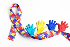 Autism awareness concept with colorful hands on white background. Top view