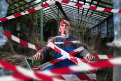 Autistic wrapped in crime-scene tape on the field Stock Photos Autistic wrapped in crime-scene tape on the field Stock Photos