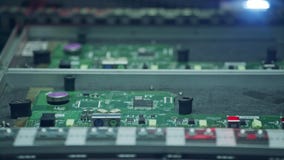 Automated SMT machine placing electronic components on a board.
