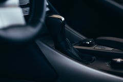 Selector automatic transmission with perforated leather in the interior of a modern expensive car. The background is blurred royalty free stock photography Selector automatic transmission with perforated leather in the interior of a modern expensive car. The background is blurred royalty free stock photography