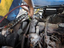 Automobile mechanic with tools in hands checking car engine in garage. Auto repair service. Stock Images Automobile mechanic with tools in hands checking car engine in garage. Auto repair service. Stock Images