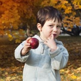 Autumn Child With Apple Stock Photo