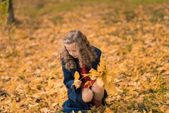 Autumn girl happy with colorful fall leaves falling stock photo Autumn girl happy with colorful fall leaves falling stock photo