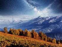 Autumn landscape and snow mountains in beautiful cumulus clouds. Main Caucasian Ridge. Type Mount Ushba Mheyer, Georgia Royalty Free Stock Photo Autumn landscape and snow mountains in beautiful cumulus clouds. Main Caucasian Ridge. Type Mount Ushba Mheyer, Georgia Royalty Free Stock Photo