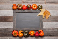 Autumn leaves, pumpkins on wooden background with copy space on chalkboard royalty free stock photography Autumn leaves, pumpkins on wooden background with copy space on chalkboard royalty free stock photography